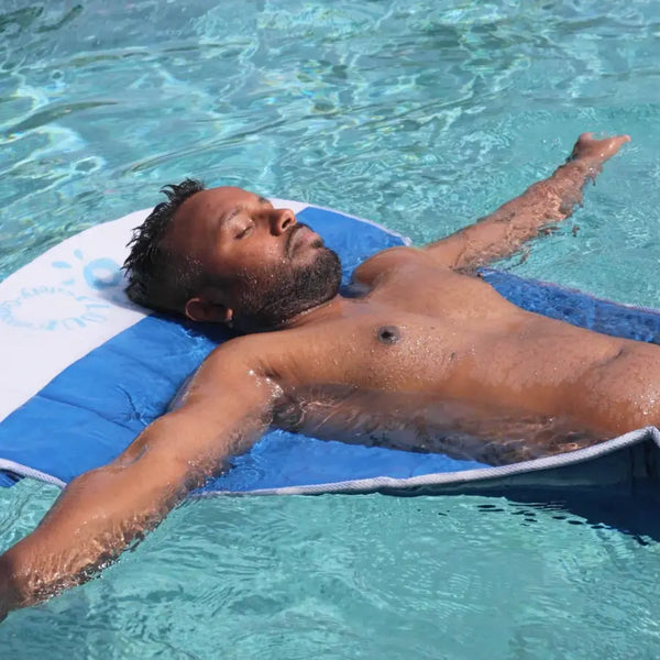 A man relaxing on the floating mat  Safety Concept  by Plouf